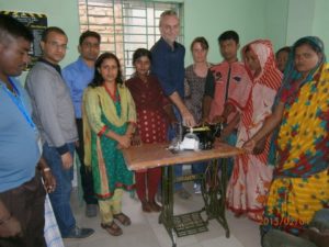 Social workers and I with members of the Wastepickers Cooporative presenting the young man with his sewing machine