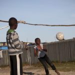 Children play by Khayelitsha township near Cape Town