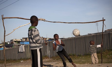 Children play by Khayelitsha township near Cape Town