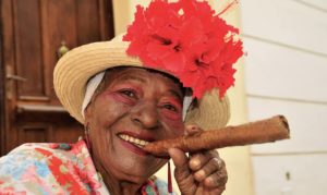 Woman in a hat posing with a cigar