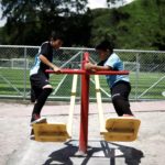 Children play on swings