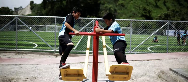 Children play on swings